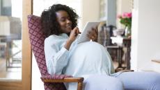 Pregnant person using tablet
