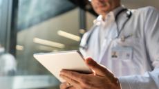 Doctor reading a medical chart from a digital tablet