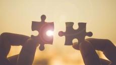 Puzzle pieces fitting together, showing connection and success
